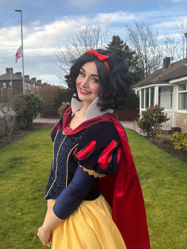 Apple Princess, with short black hair and in her signature royal blue and yellow gown