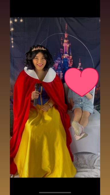 Apple Princess, with short black hair and in her signature royal blue and yellow gown