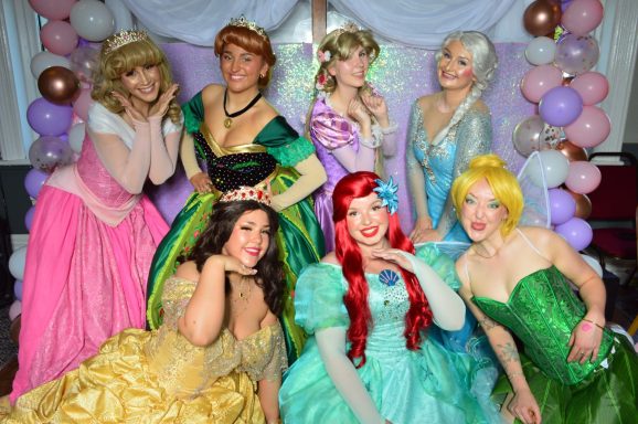 7 princesses posing, including Sleeping Princess, Snow Sisters, Tower Princess, Enchanted Rose Princess, Mermaid Princess & Green Fairy